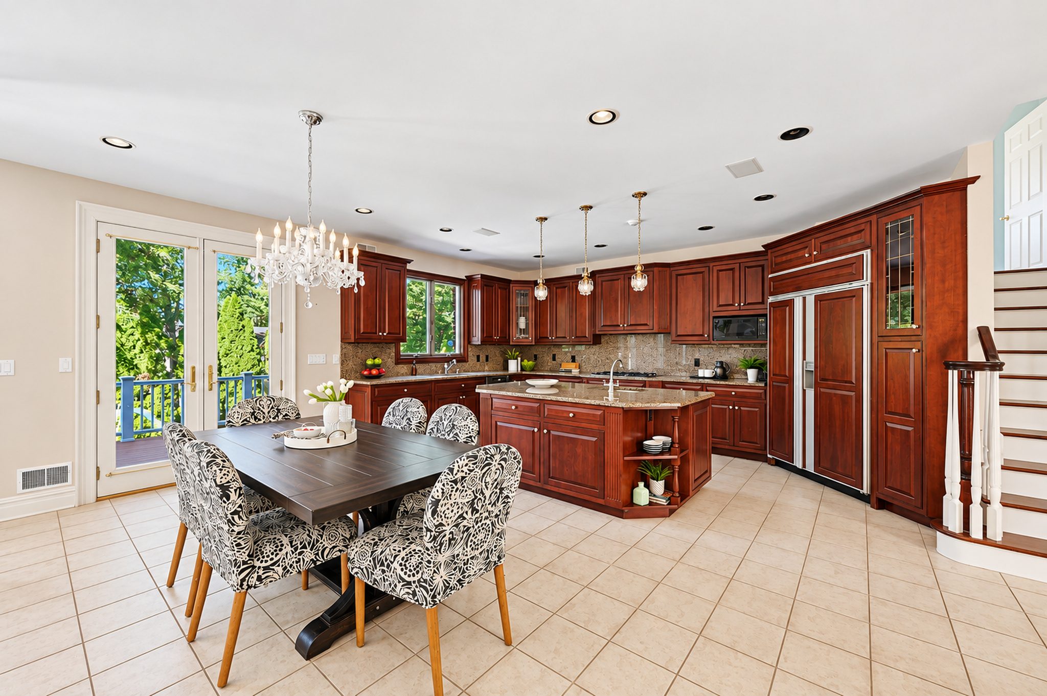Eat in kitchen with breakfast area and custom wood cabinetry at 54 Burnet Hill Road, Livingston