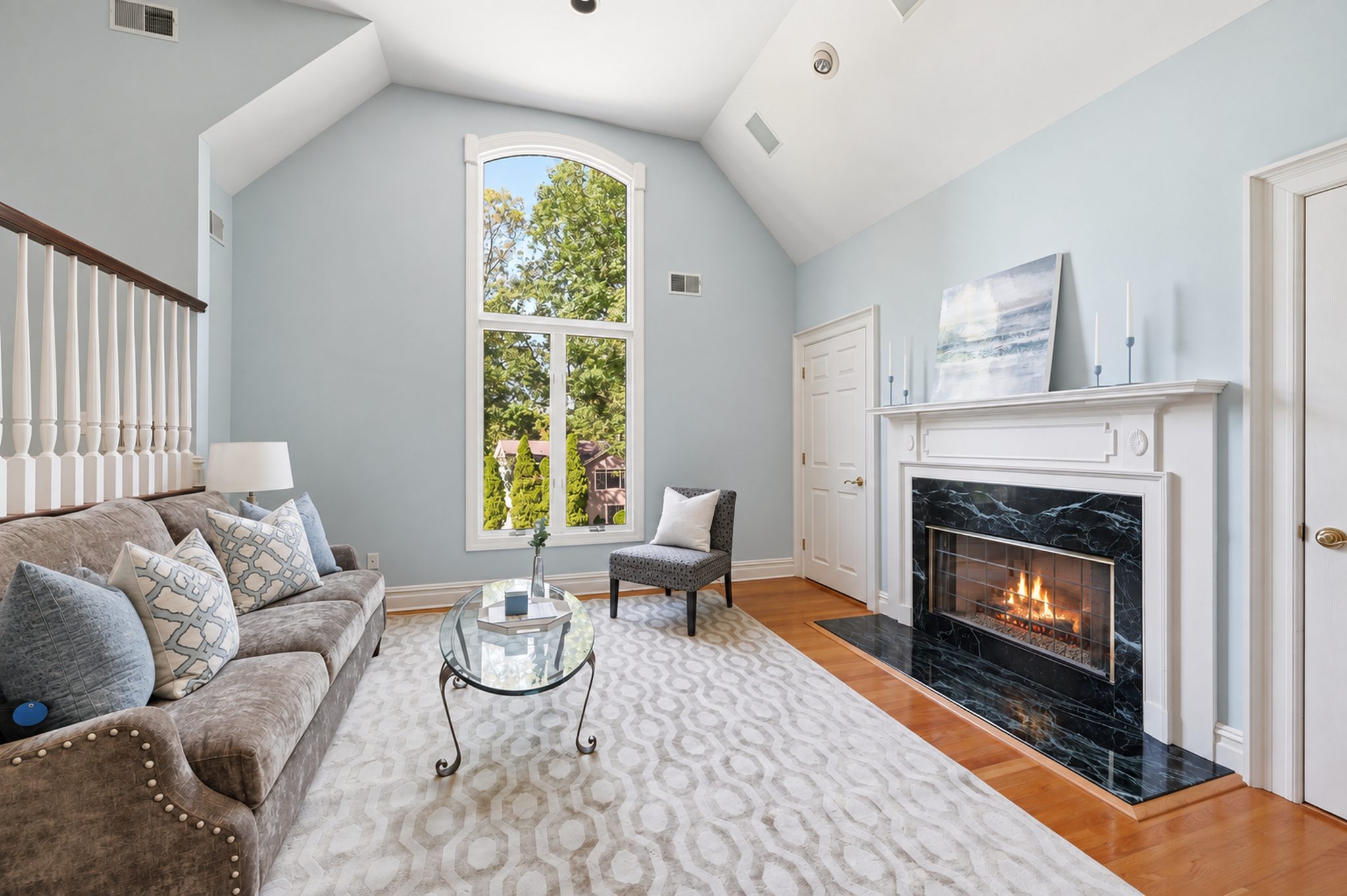 Primary suite sitting room with fireplace and arched window at 54 Burnet Hill Road, Livingston